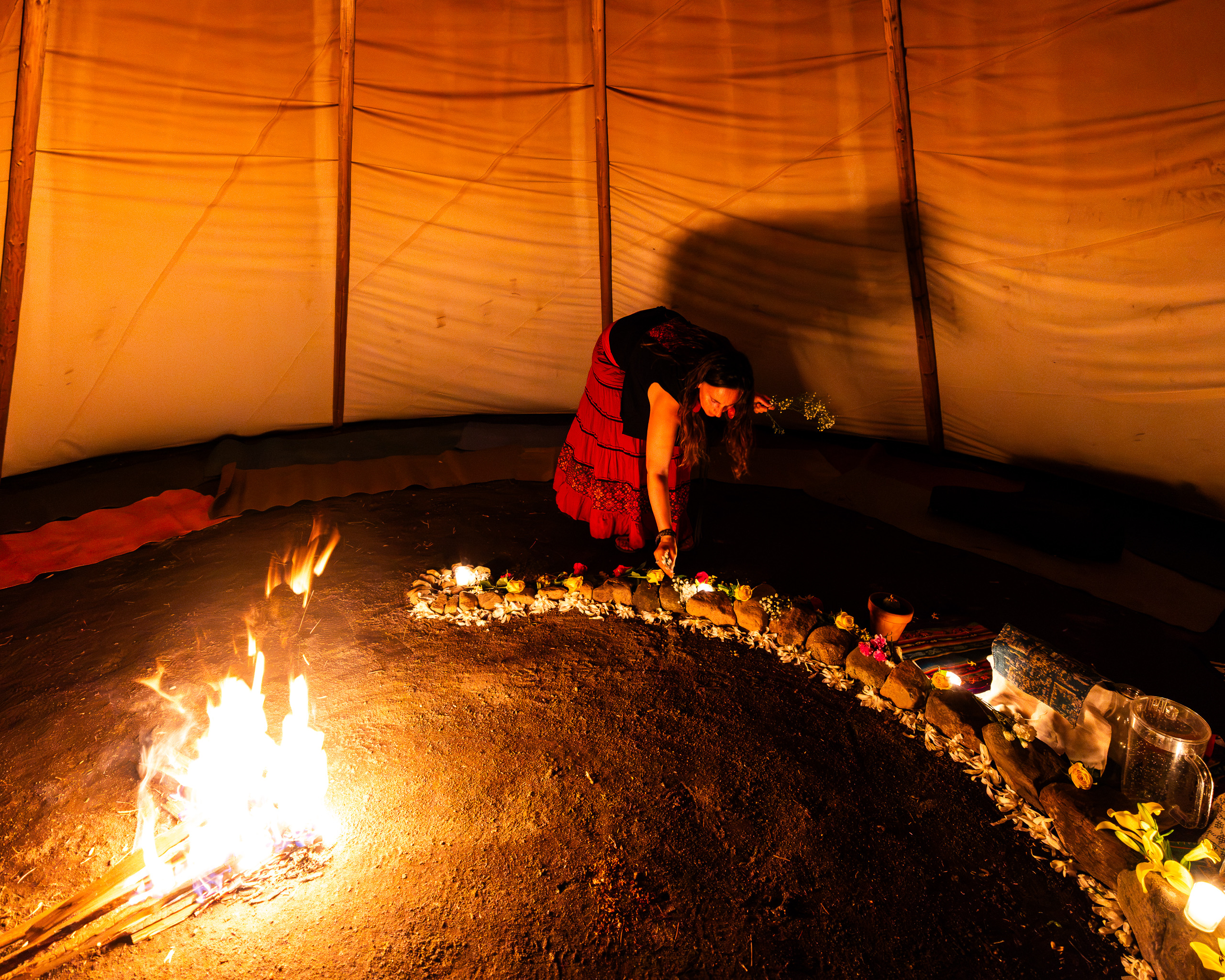 Flowers placed along the stone ring by firelight