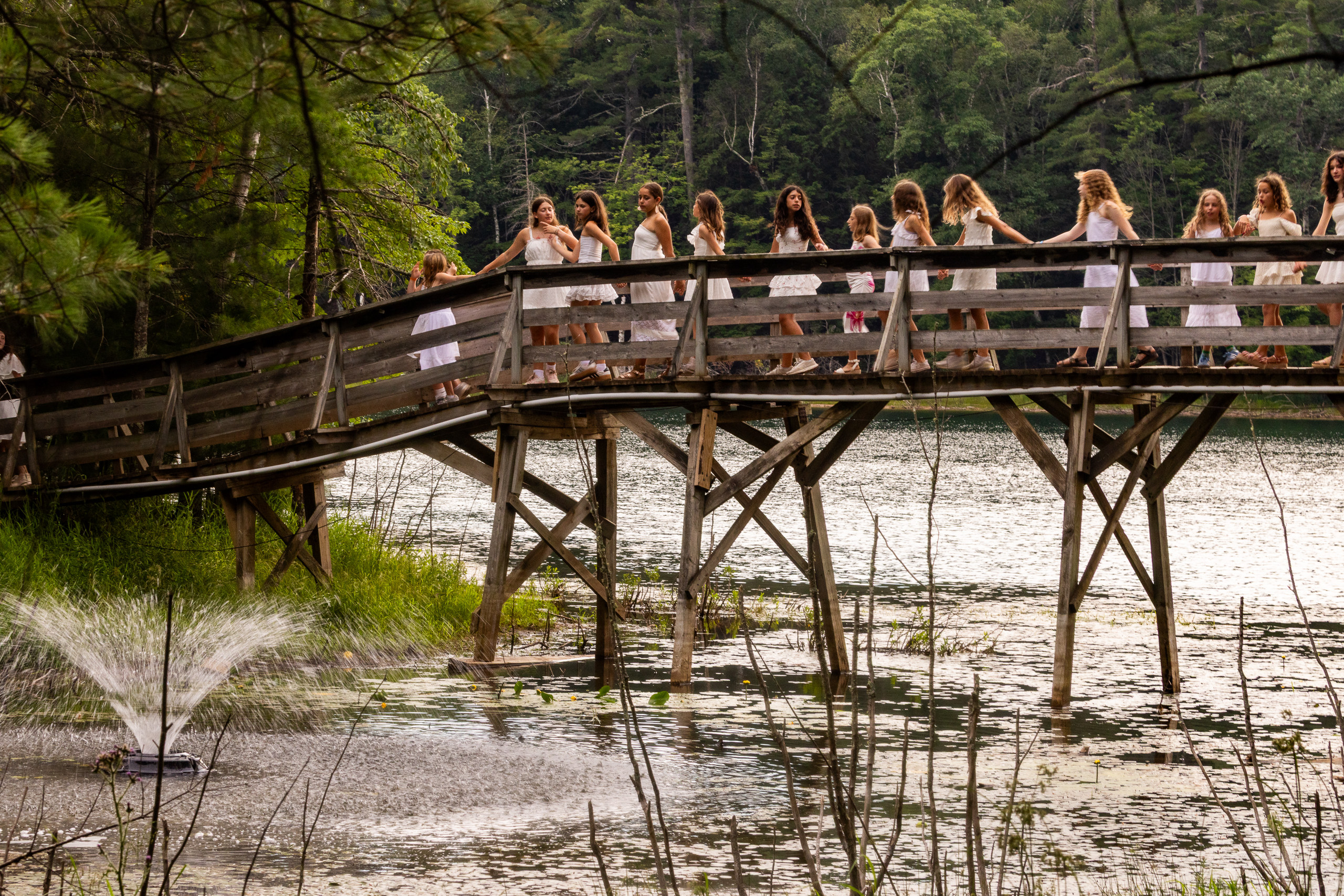 The whole camp crossing a wooden bridge into Shabbat